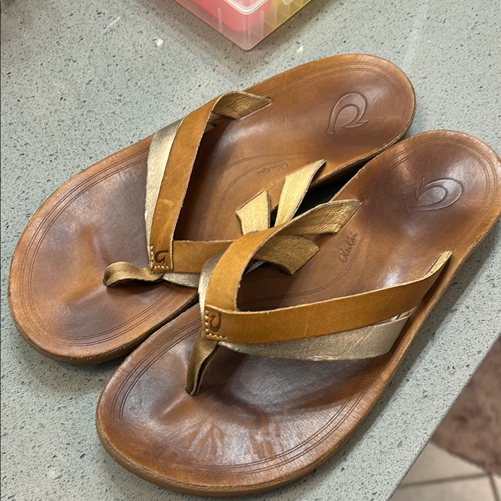 OluKai Brown and Gold Sandals with Thong Design